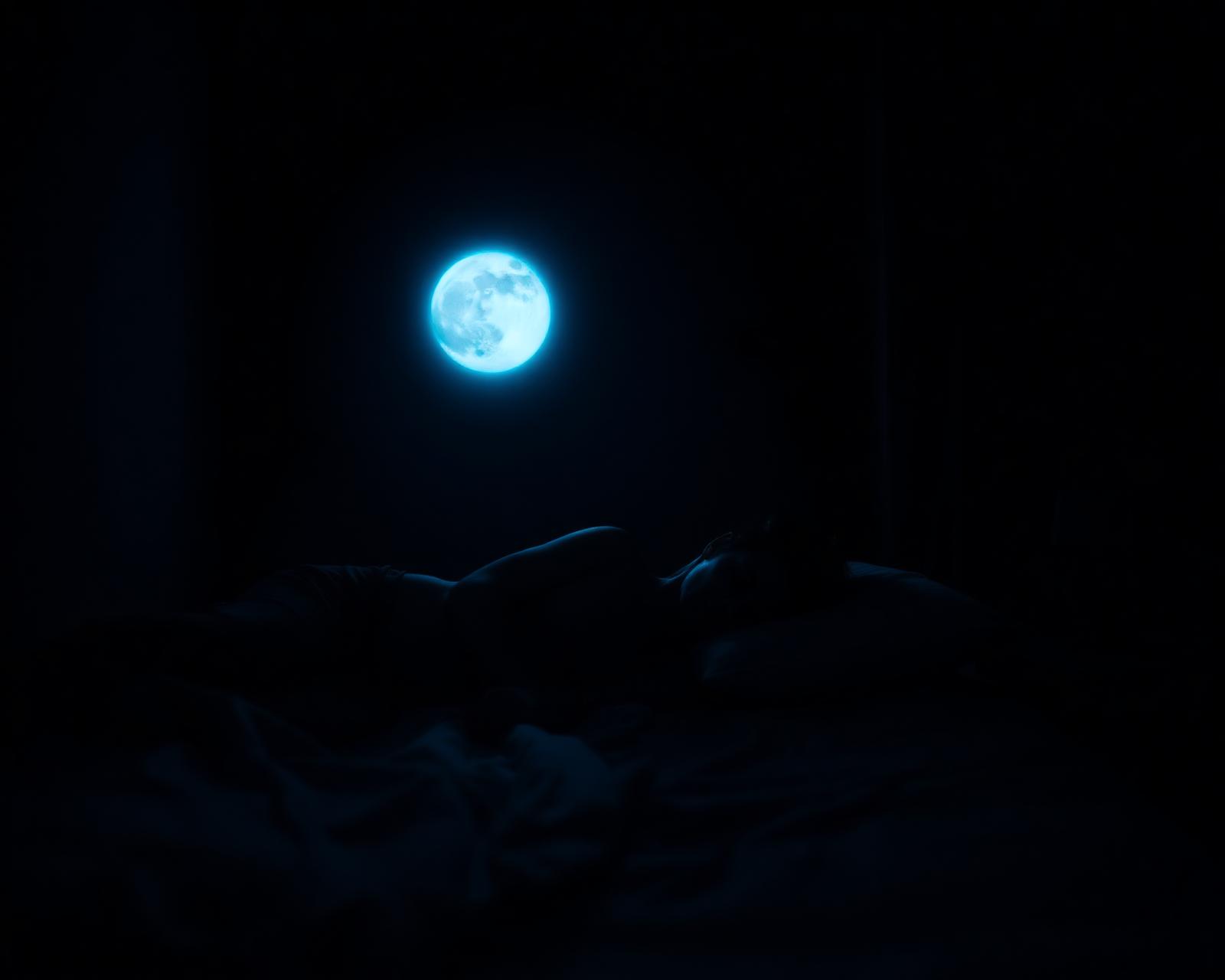 Person sleeping peacefully under cool moonlight